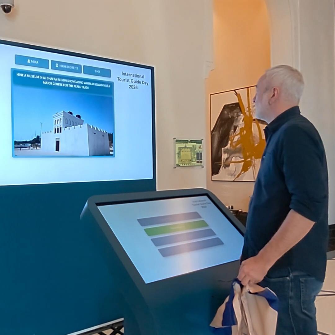 Multi-screen interactive UAE landmark guessing game display with custom branded interface for immersive event activation and digital tourism engagement.